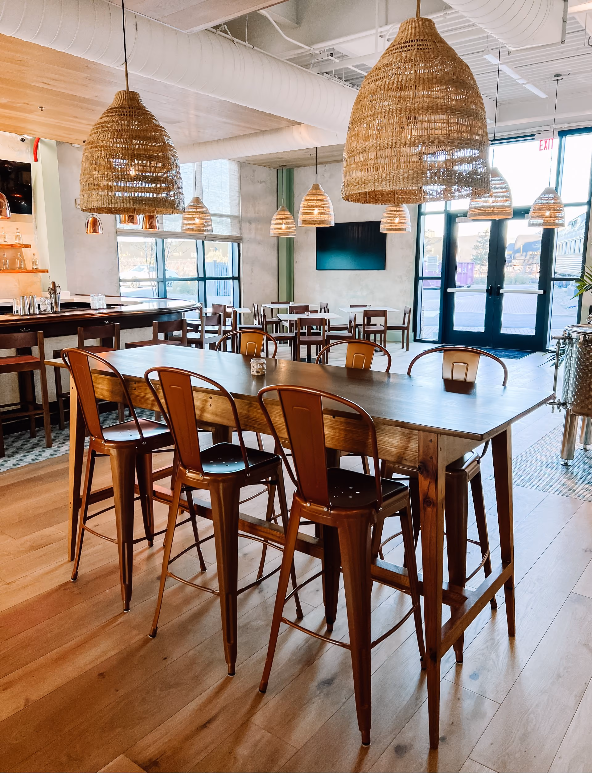 Bar and dining area with wood tables and hardwood flooring