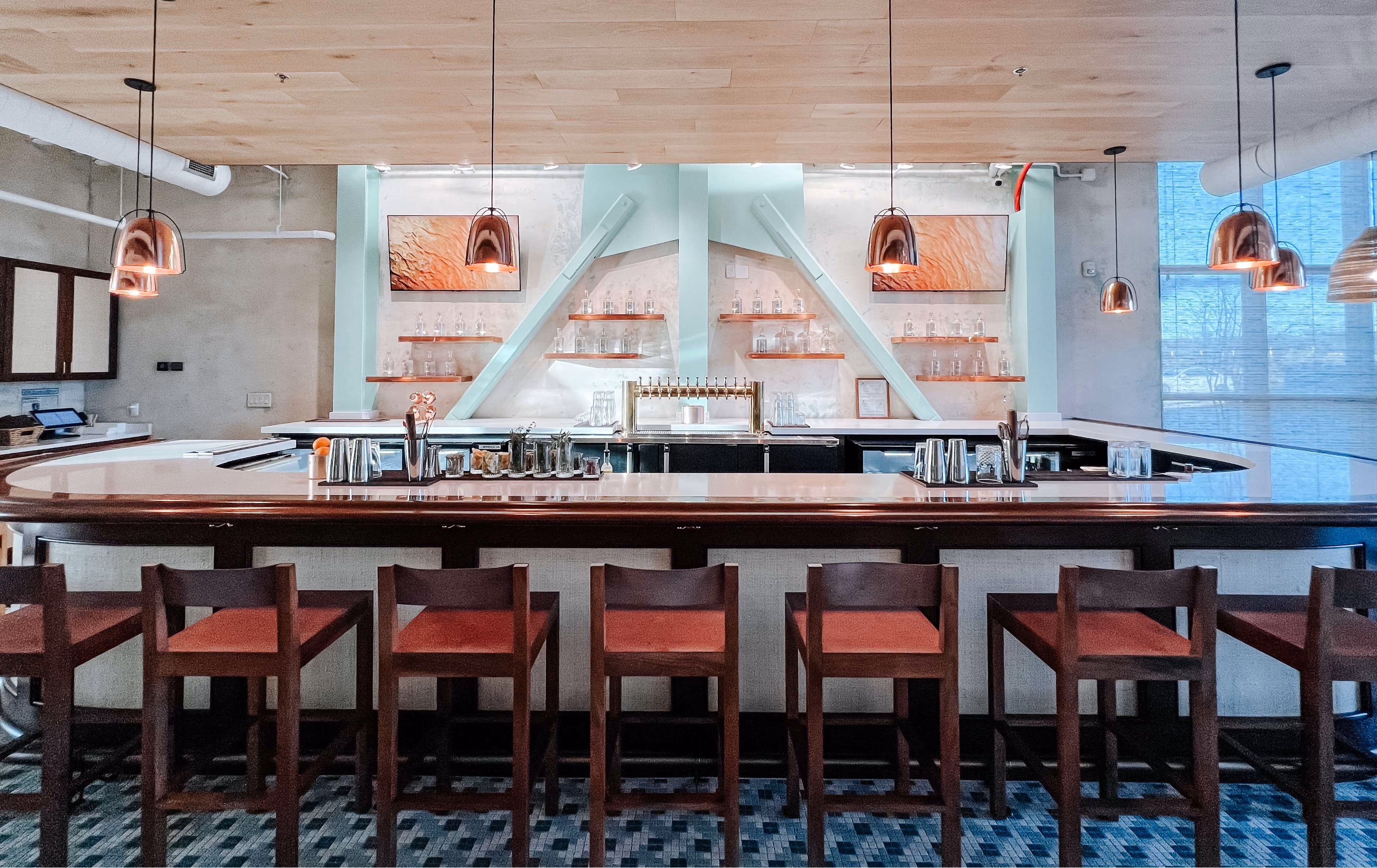 Bar area with red stools and patterned tile flooring