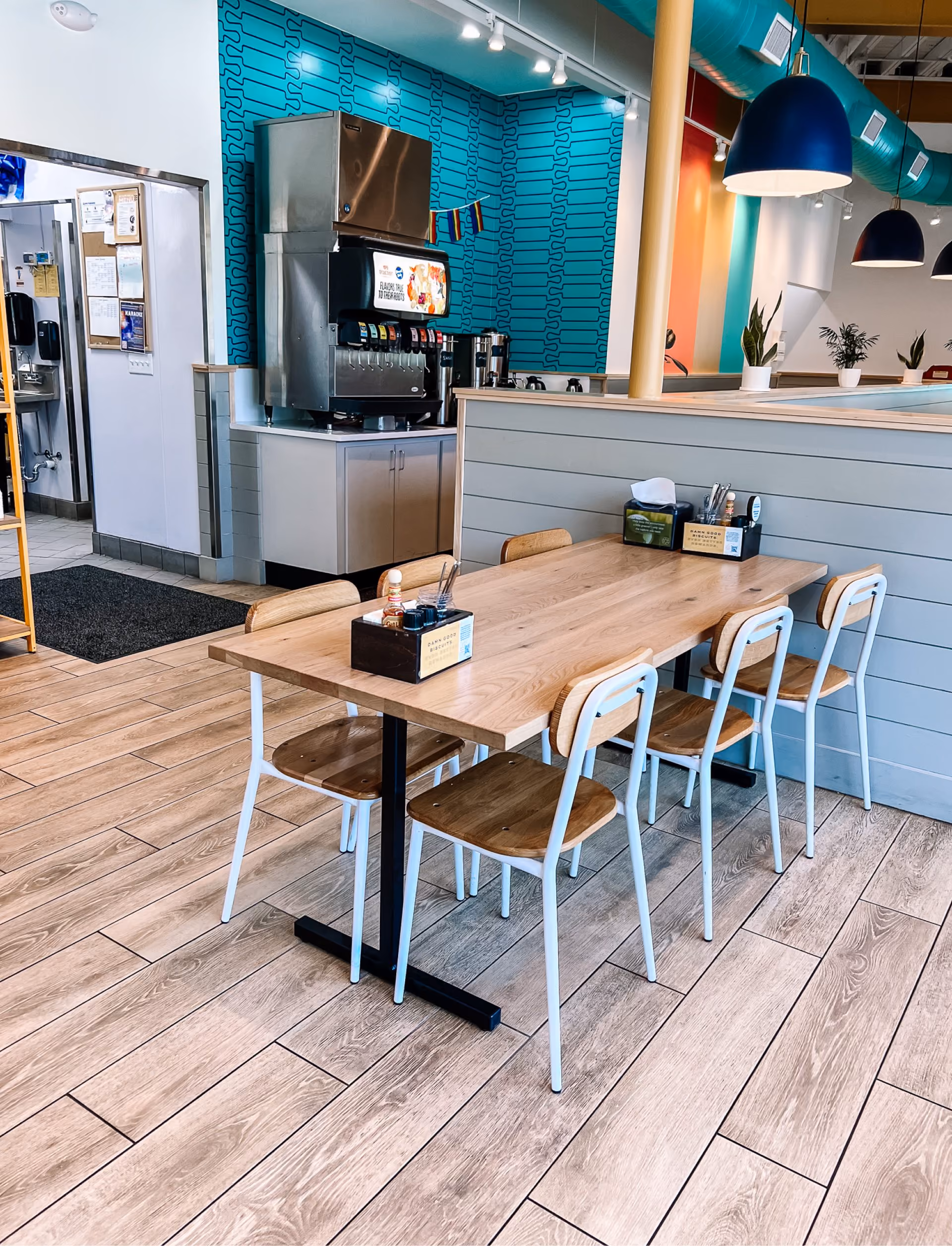 Restaurant dining area with wood tables and terrazzo-look tile flooring
