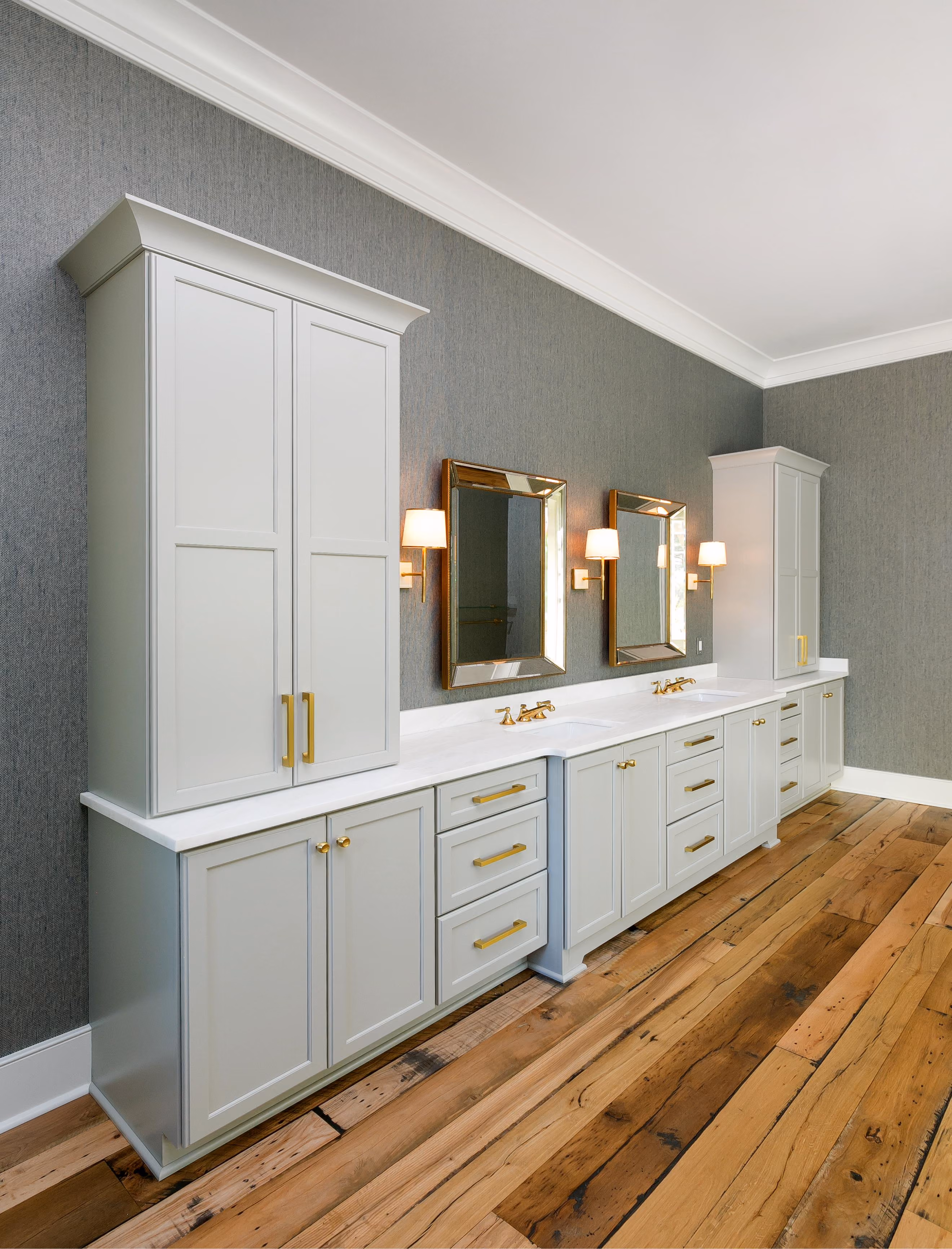 Dressing area with mirrored cabinetry and hardwood flooring