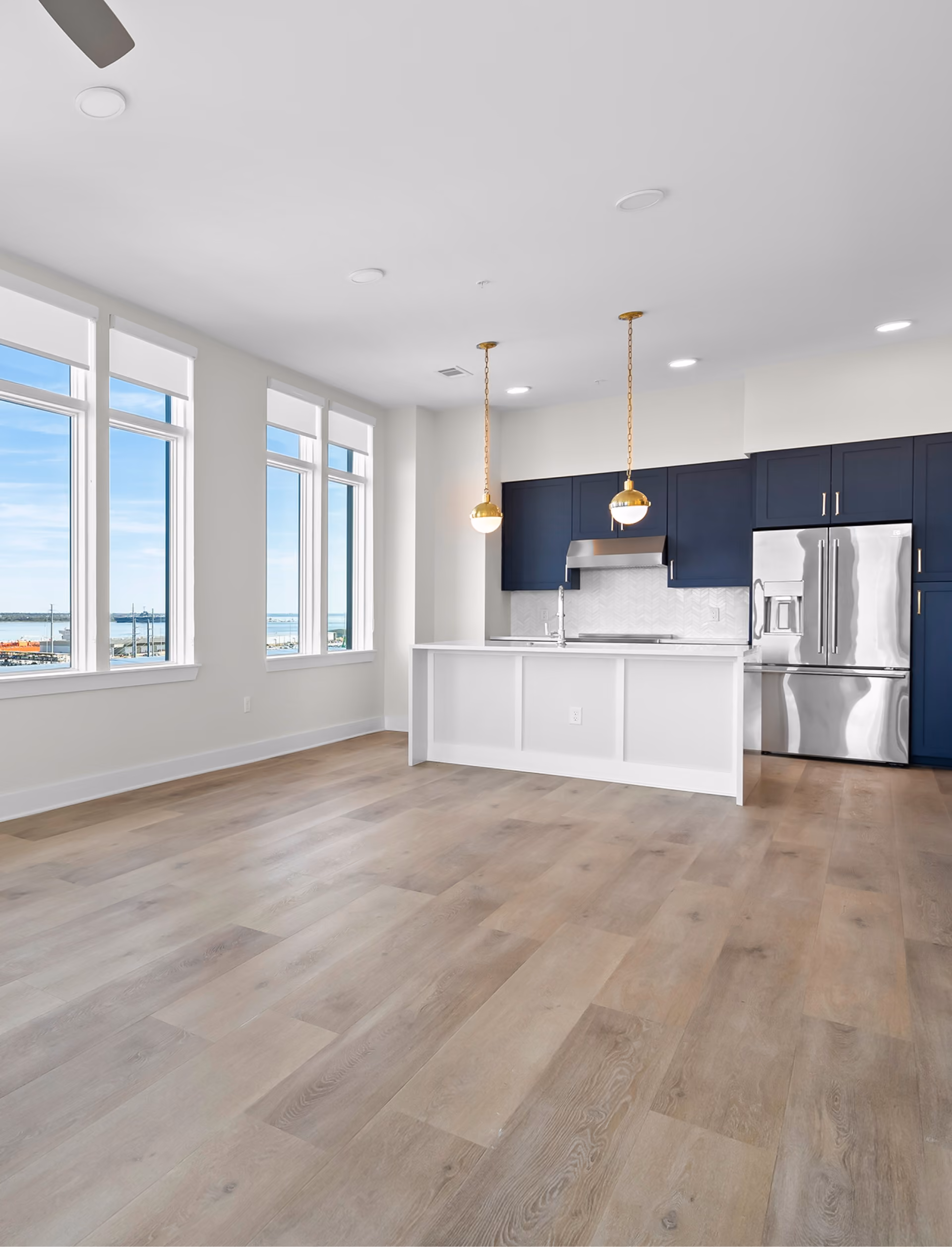 Open-concept living and kitchen area with wood-look flooring