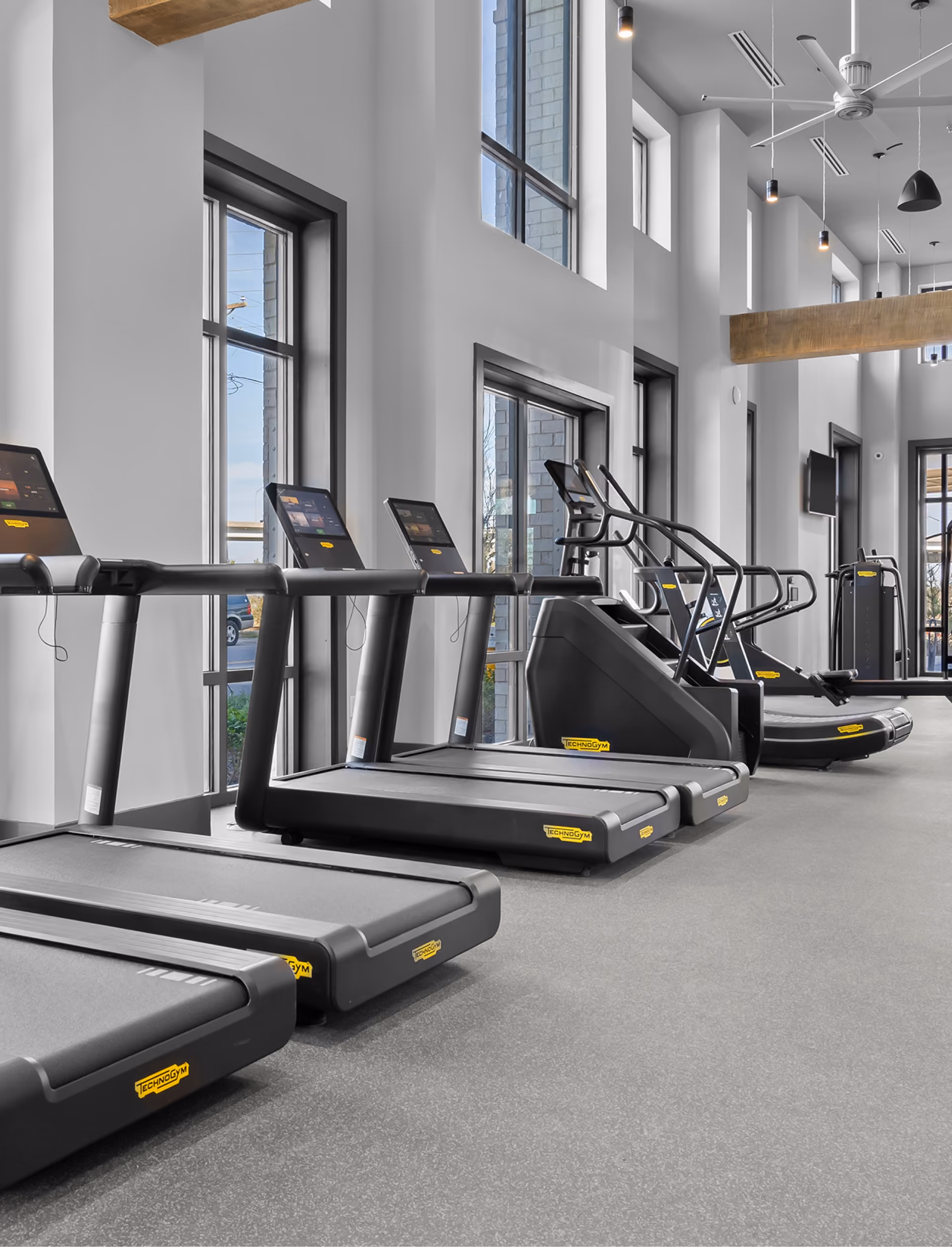Fitness center with treadmills on rubber flooring