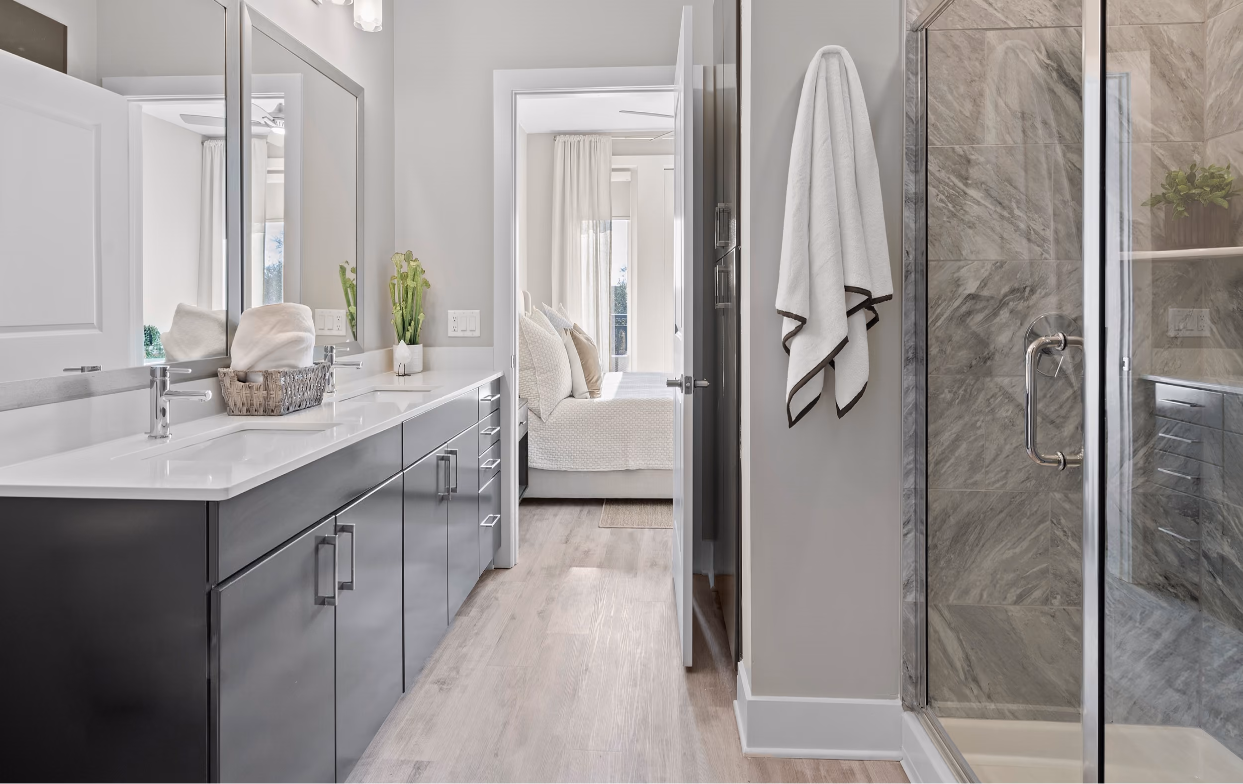 Bathroom with marble tile walls and a glass shower