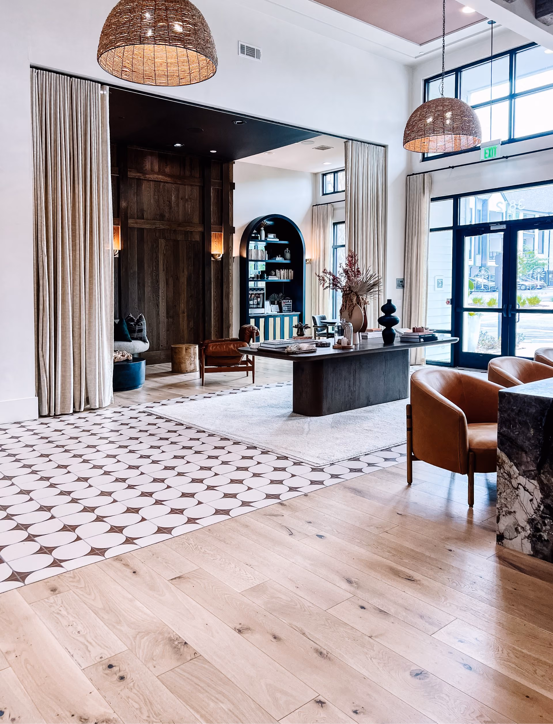 Lounge with bookshelves and patterned tile flooring