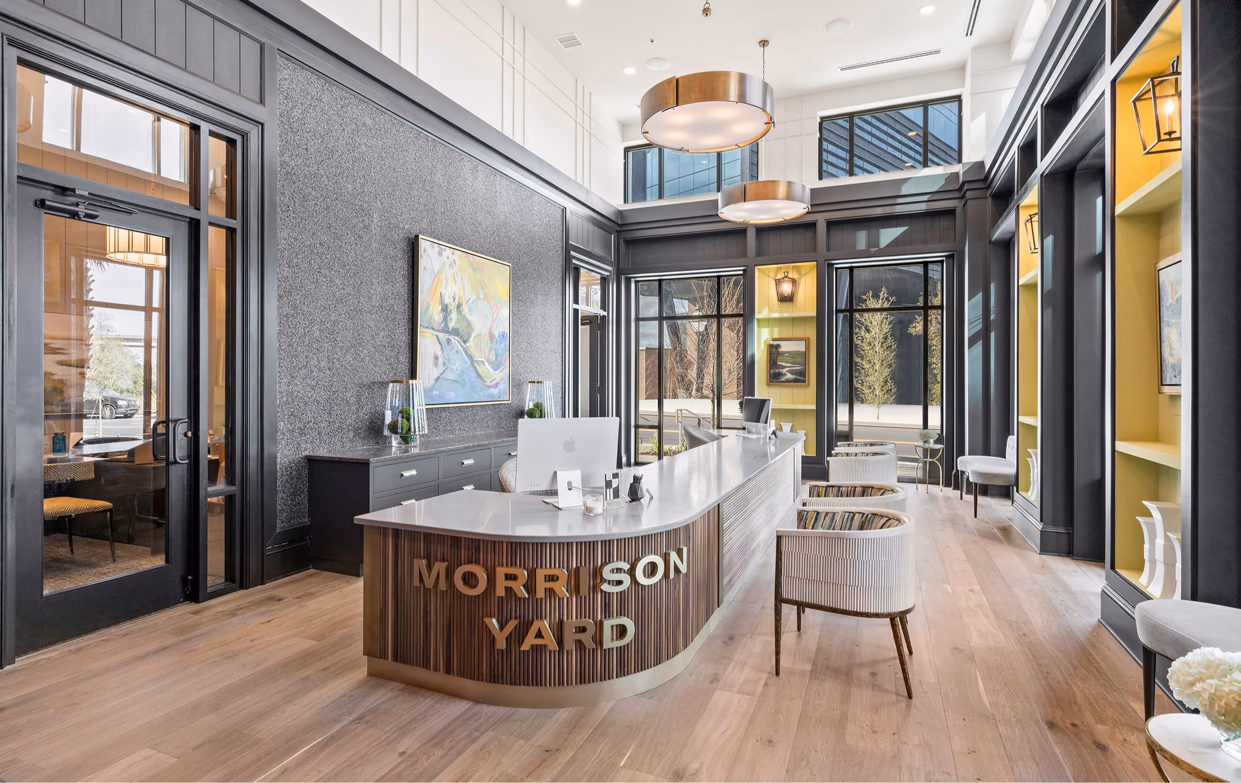Lobby lounge with Morrison Yard branding and wood-look flooring