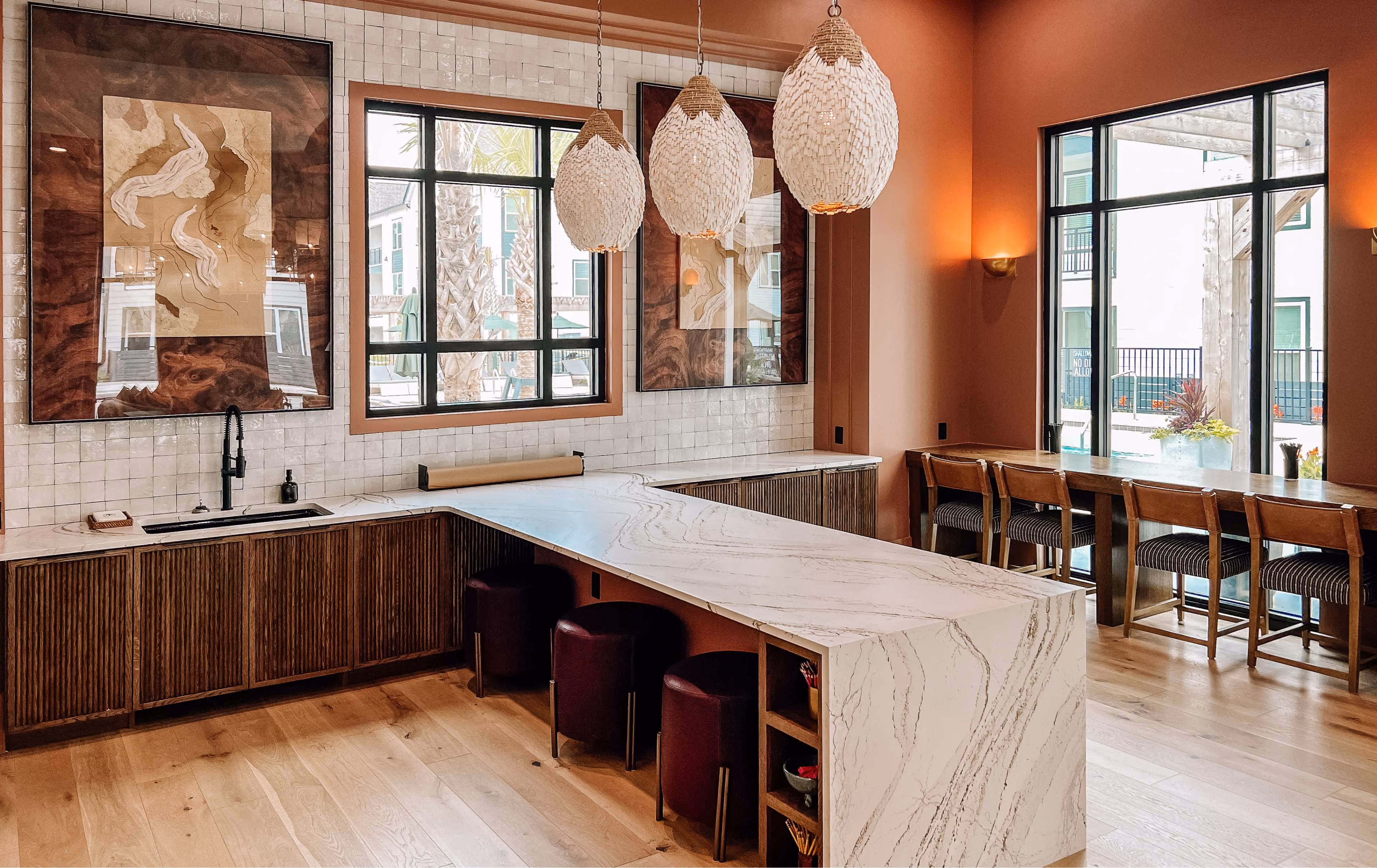 Kitchen with a marble island and a dining nook on wood-look flooring