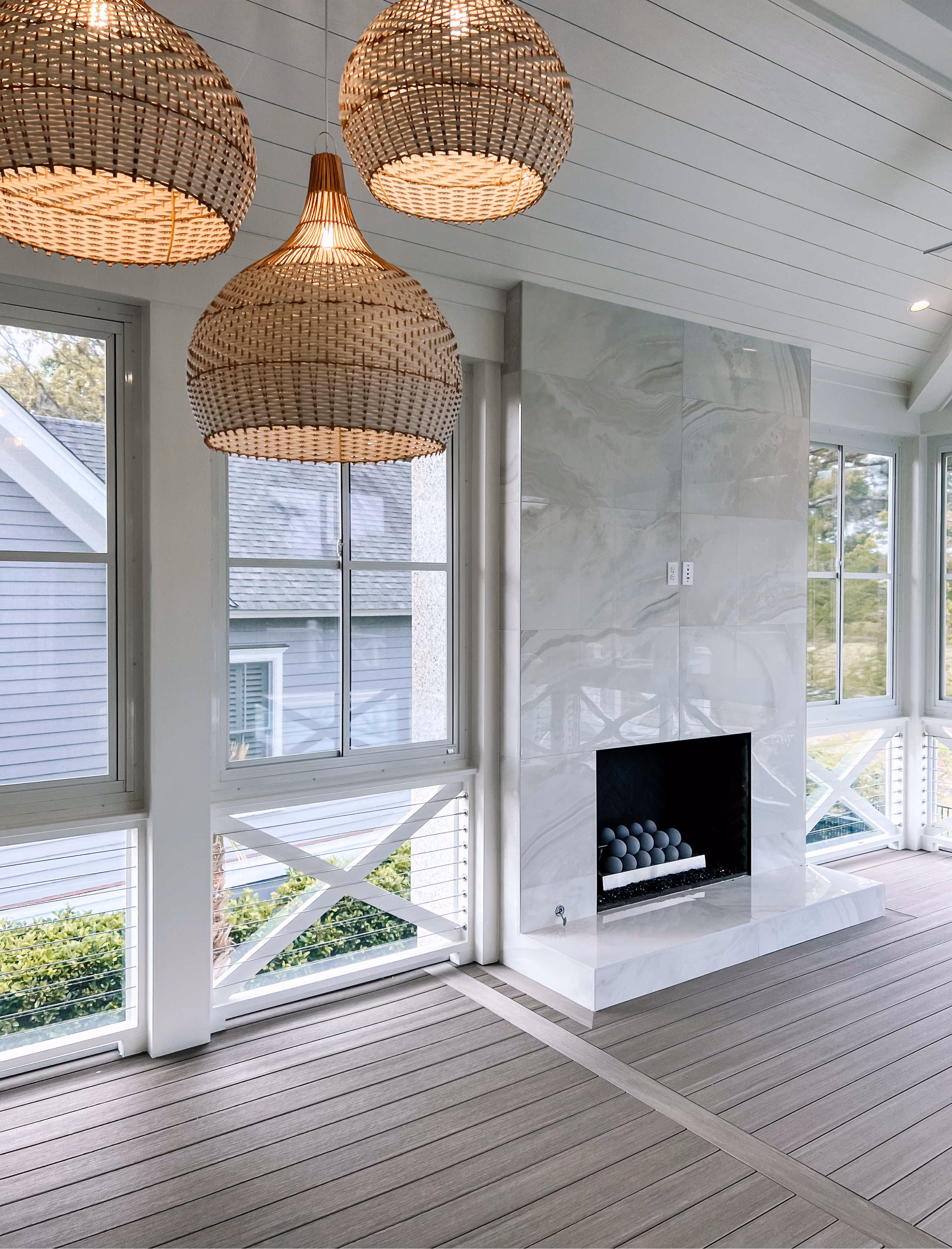 Sunroom with marble tile walls and a fireplace