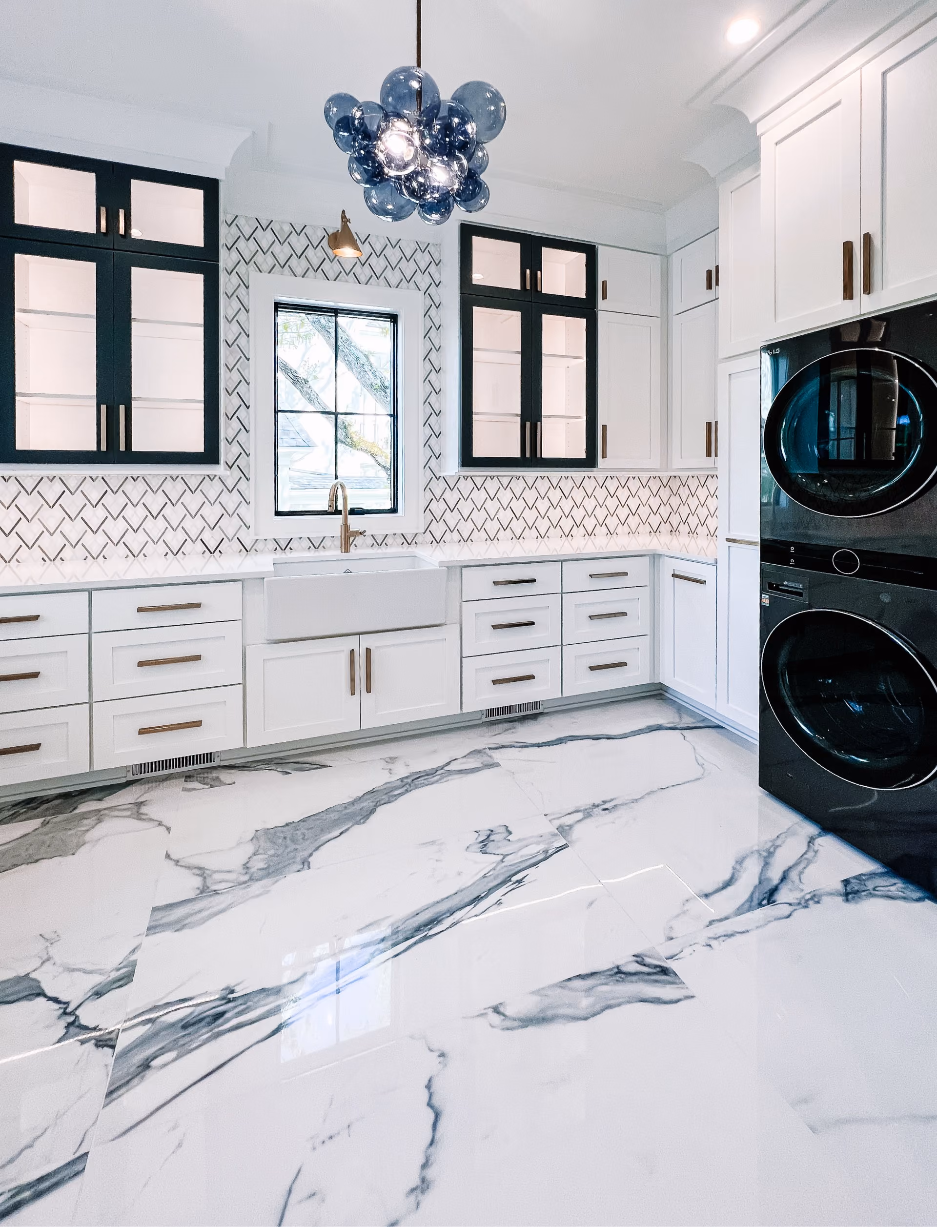 Bathroom and laundry area with a dramatic marble countertop and patterned tile flooring