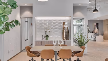 Bank lobby waiting area with a 3D wall panel and wood-look flooring