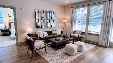 Student housing living room with a sofa and wood-look flooring
