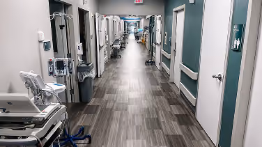 Healthcare facility corridor with gray plank flooring