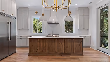 New-construction kitchen with a wood island and wood-look flooring