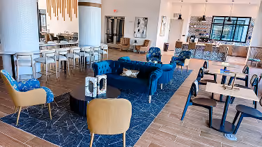 Hotel lobby lounge with a navy sofa and patterned flooring