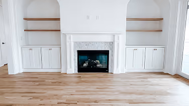 Living room with a fireplace and hardwood flooring