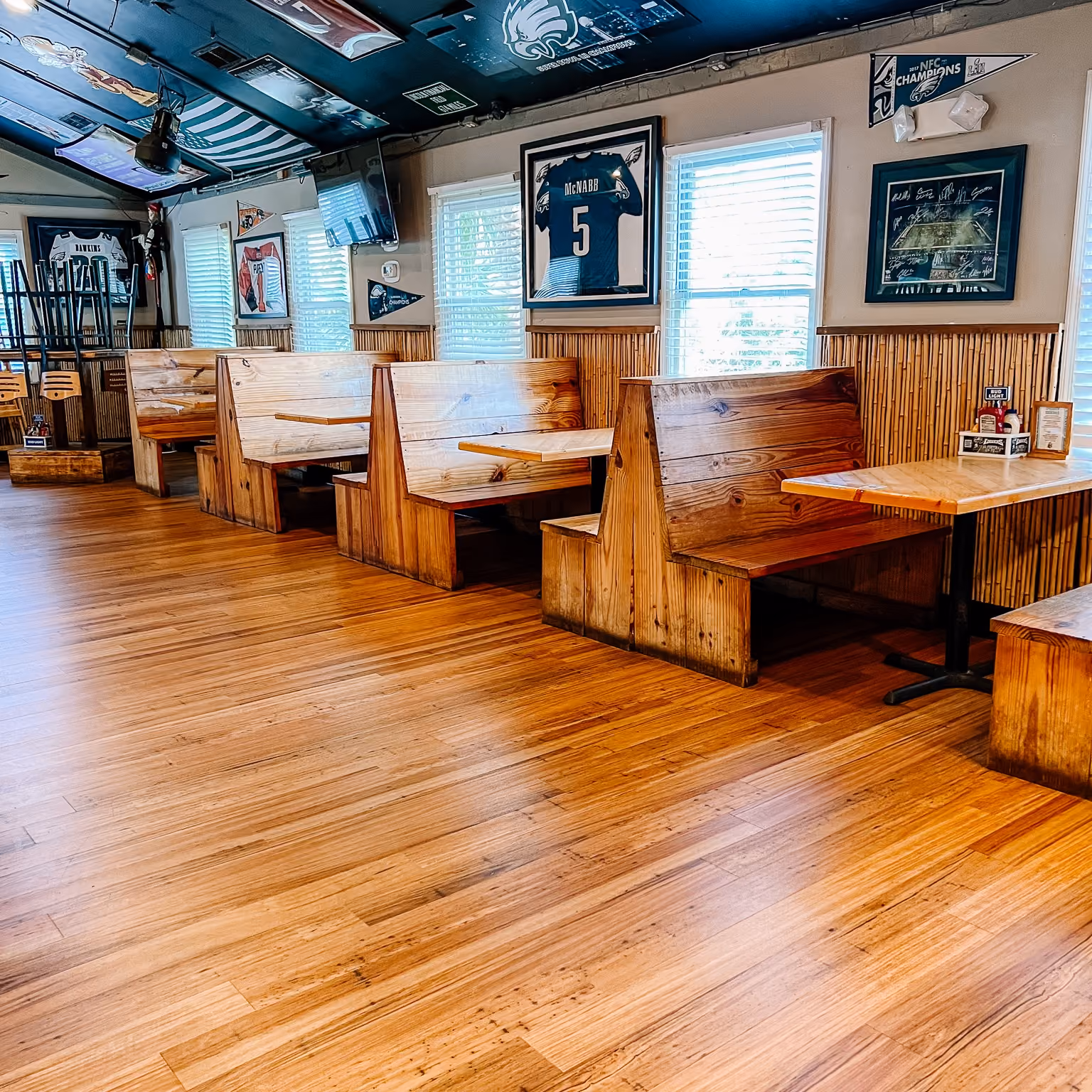 Hotel restaurant dining area with wood-look flooring and booth seating
