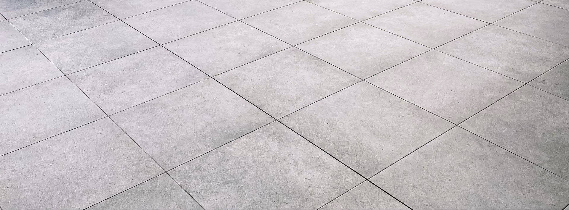 Close-up of light gray square tile flooring