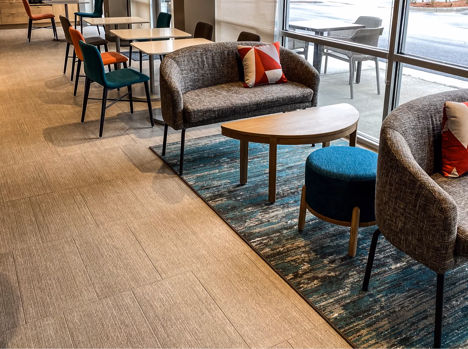 Hotel lounge with speckled terrazzo-look flooring and lounge seating