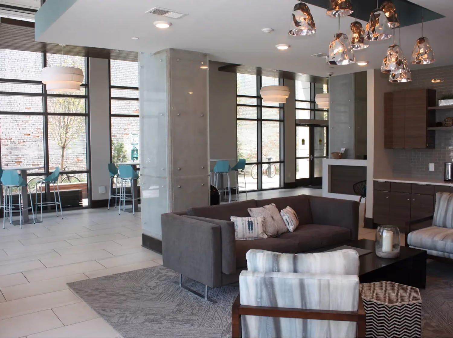 Student housing common area lounge with sectional seating on a patterned area rug