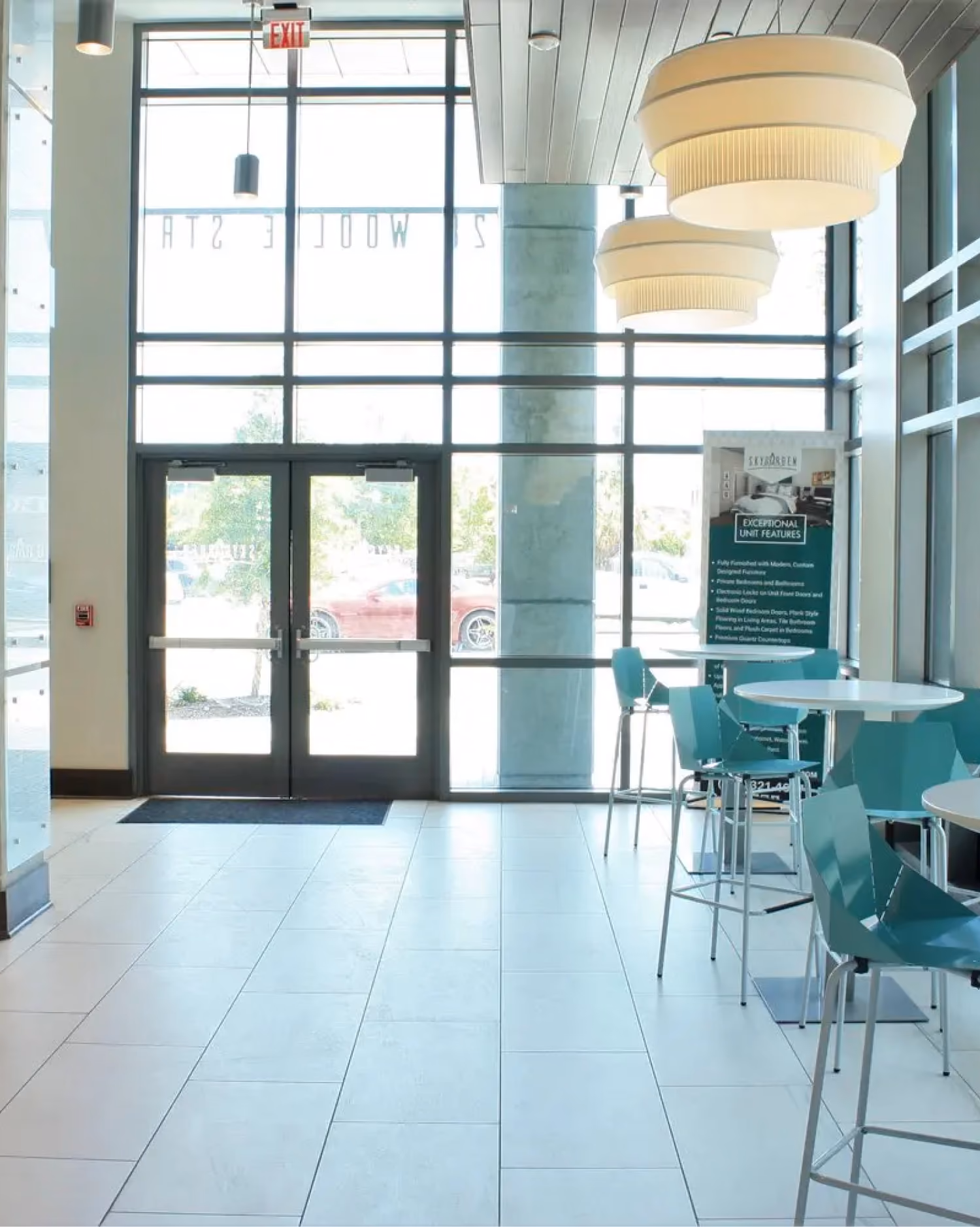 Student apartment entryway with glass doors and light tile flooring