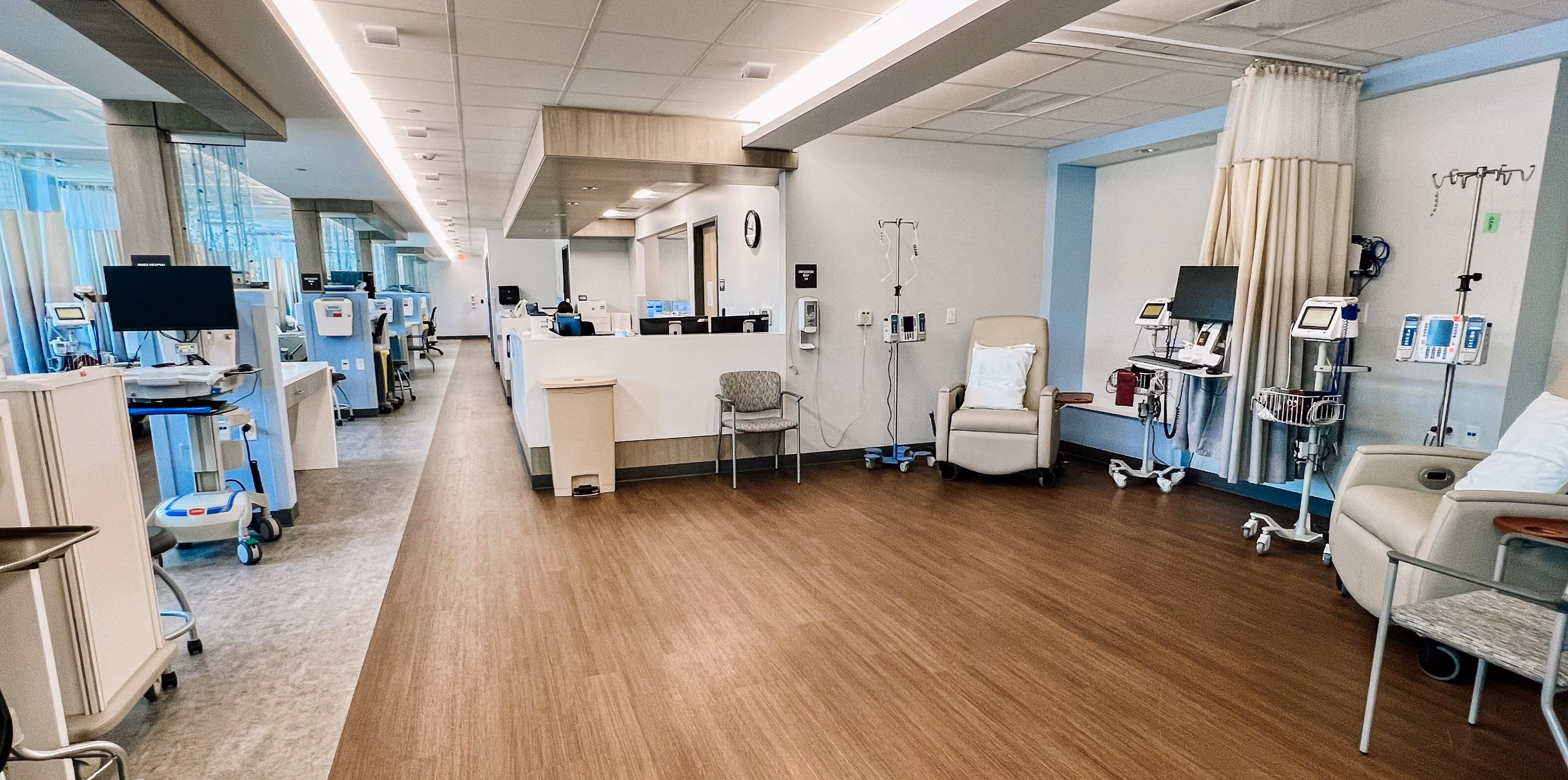 Healthcare clinic hallway with medical exam equipment and light neutral flooring