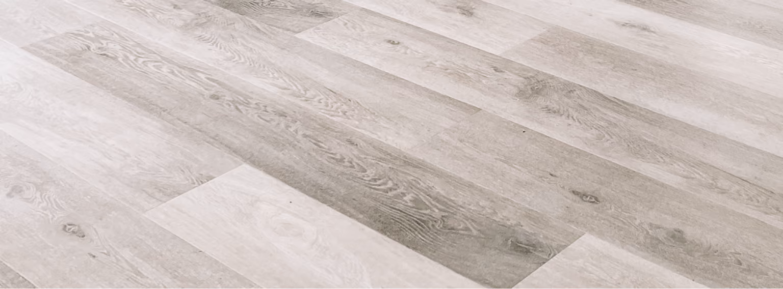 Close-up of light gray wood-look plank flooring