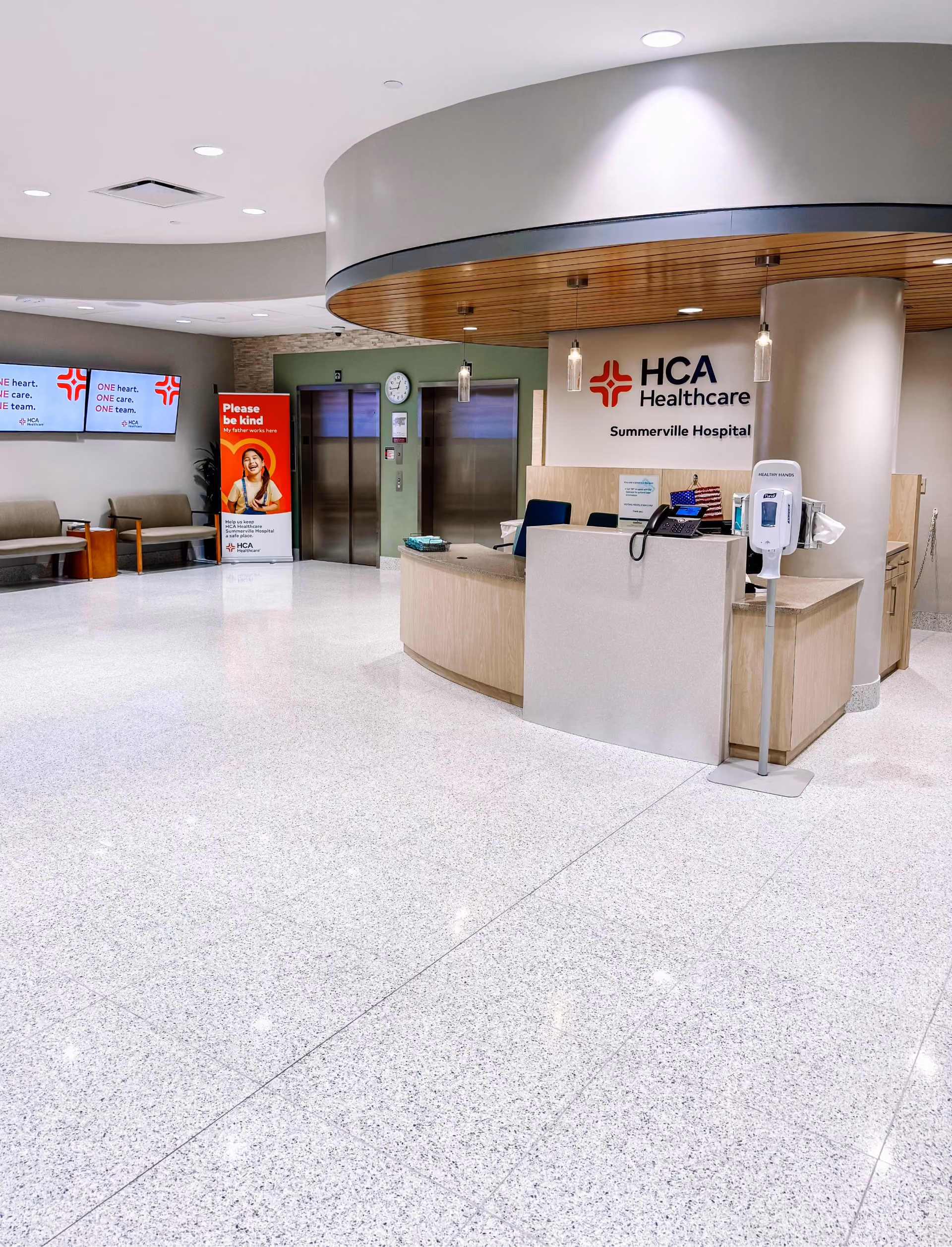 Healthcare facility reception area with terrazzo-look flooring and digital signage