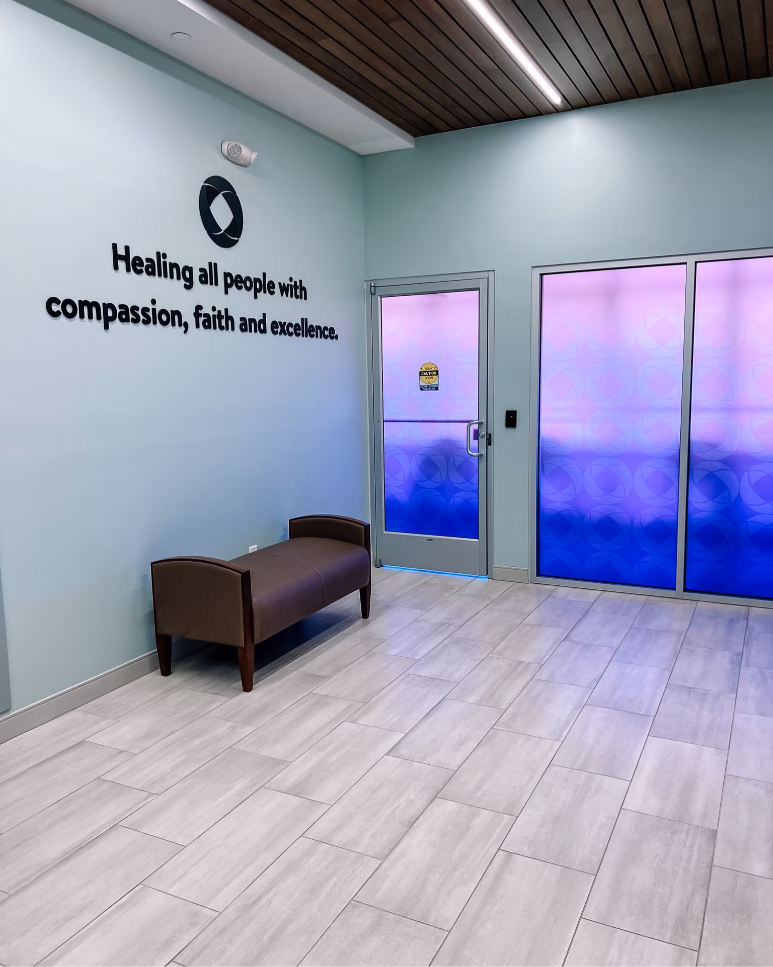 Wellness facility treatment room with accent lighting and dark flooring