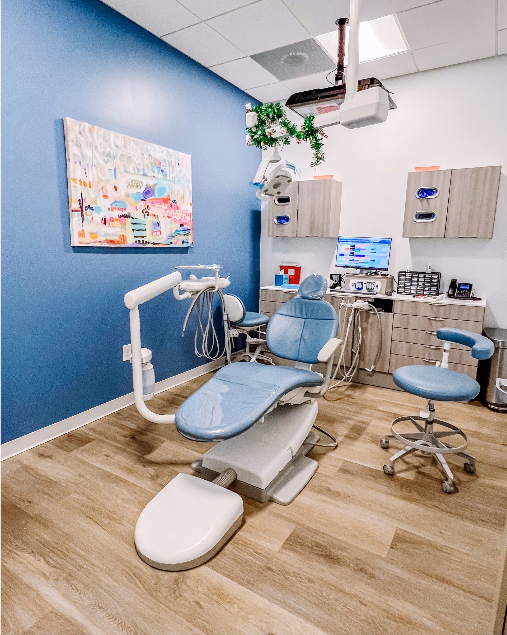 Healthcare exam room with a medical chair and patterned flooring