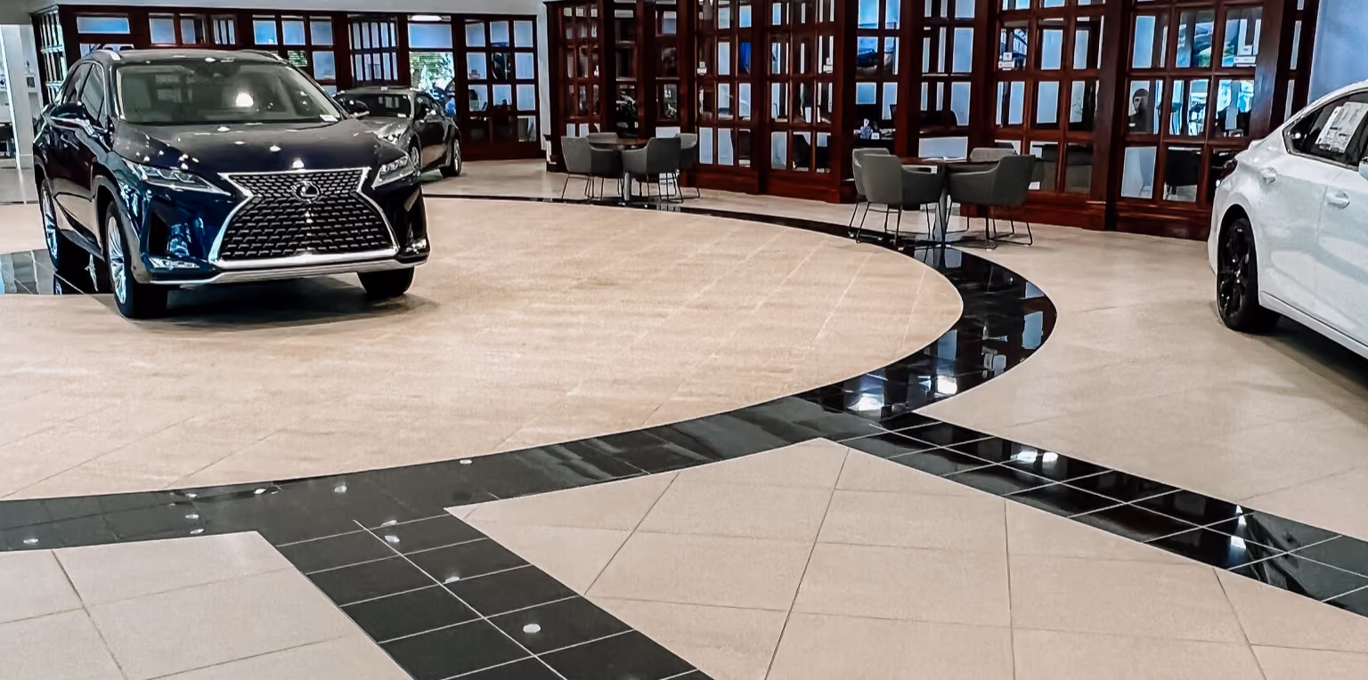 Car dealership showroom with polished dark and light patterned floor tile