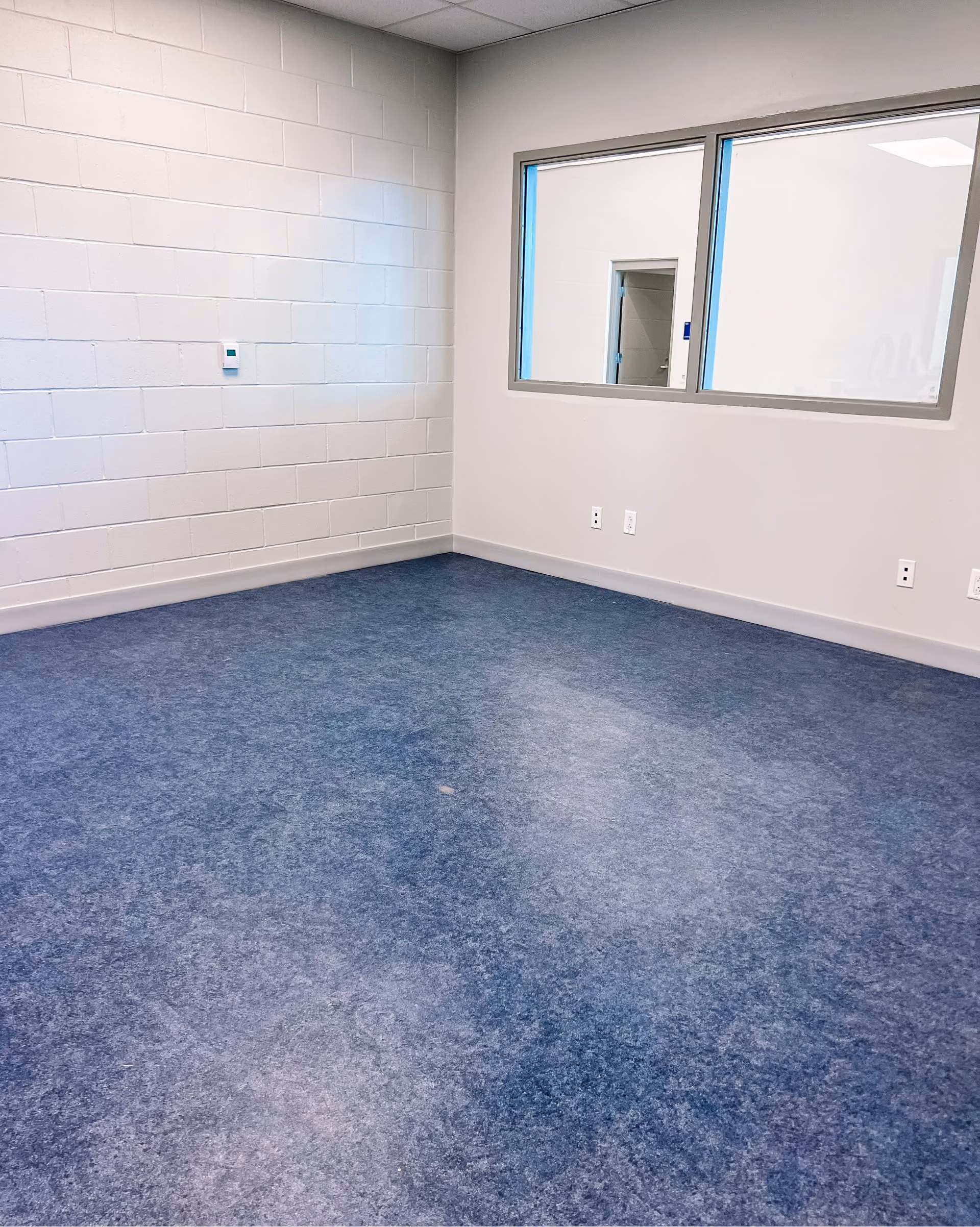 Classroom with blue speckled carpet tile flooring