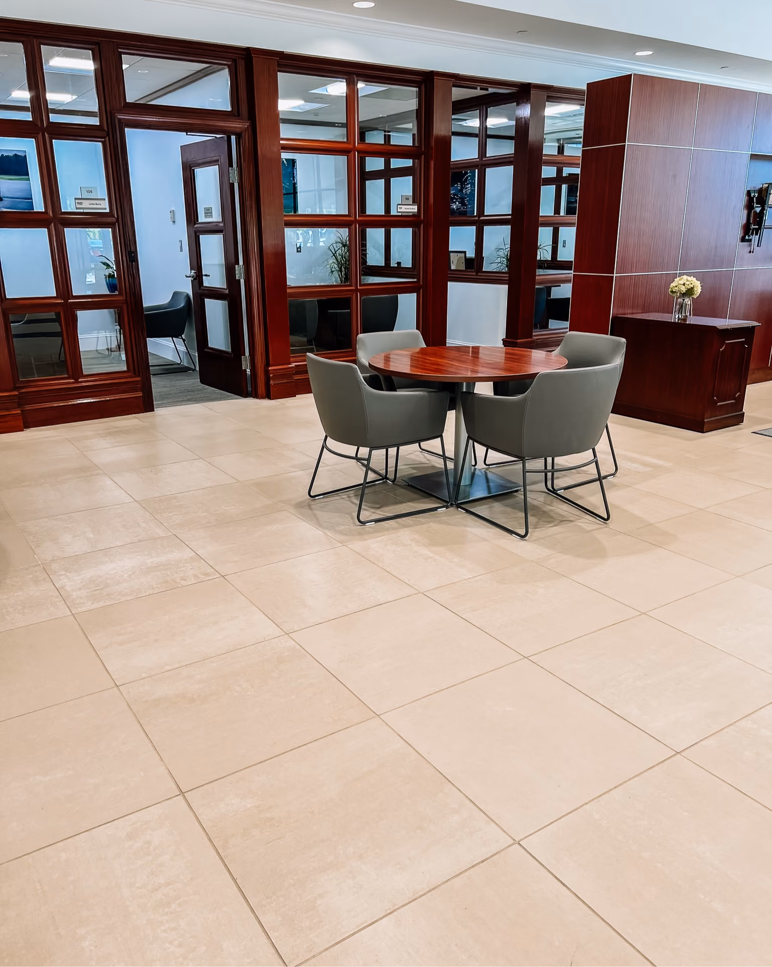 Dealership waiting area with light tile flooring and lounge seating