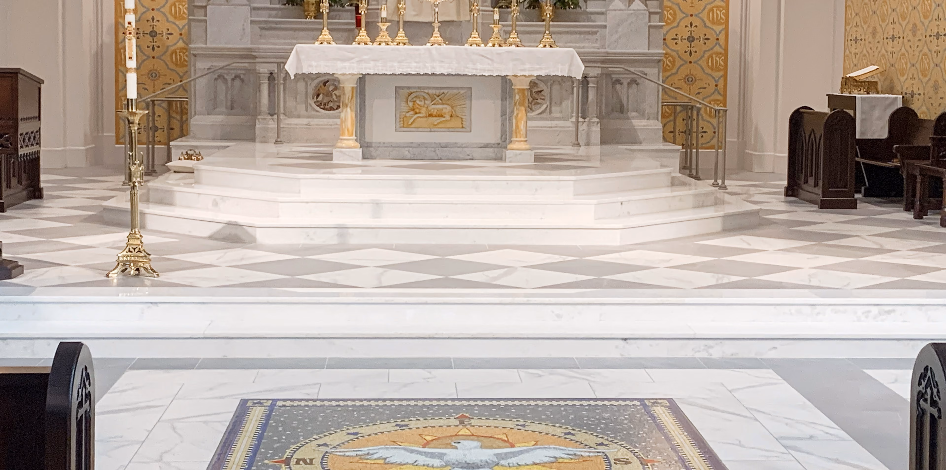 Church altar with ornate marble-look flooring and an area rug