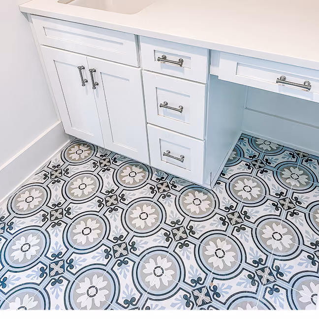 New construction bathroom with patterned cement-look floor tile and white cabinetry