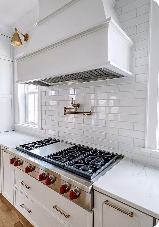 New construction kitchen with white cabinetry, dark countertops, and hardwood flooring