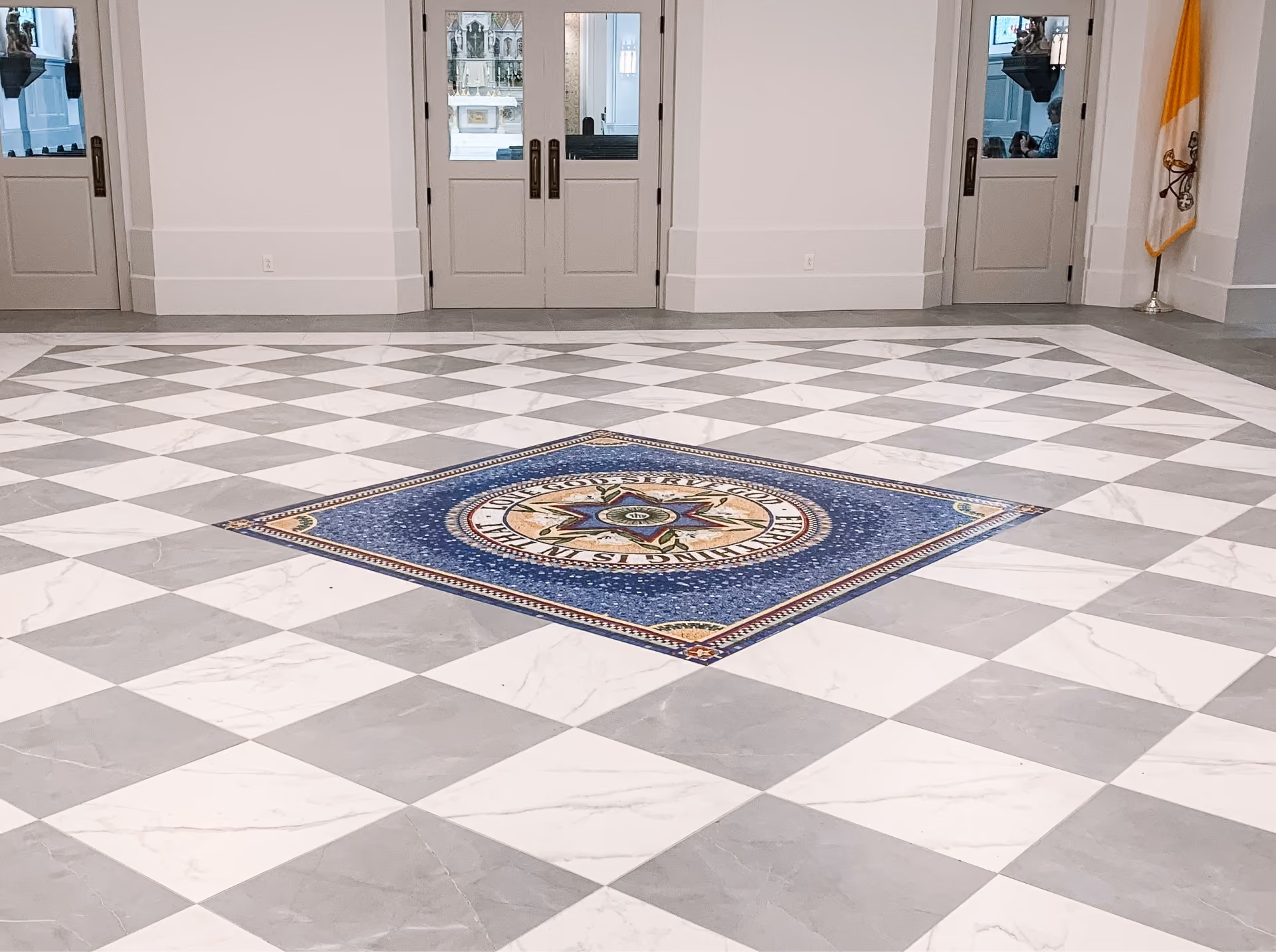 Church entryway with black and white diamond-pattern floor tile