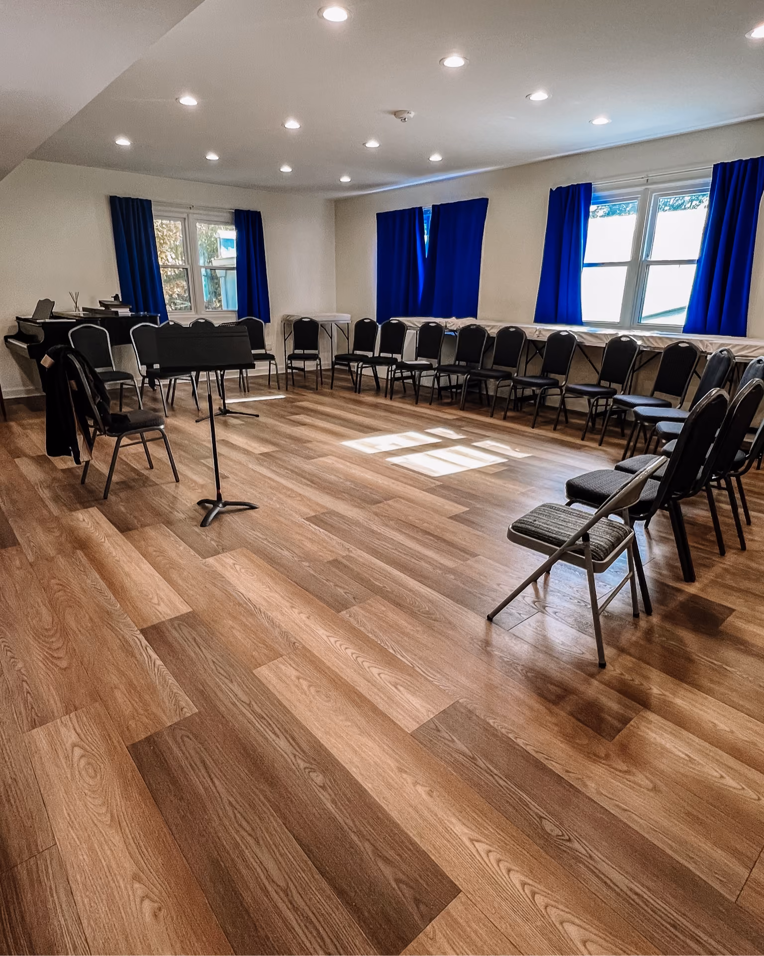 Church sanctuary with rows of chairs on wood-look flooring