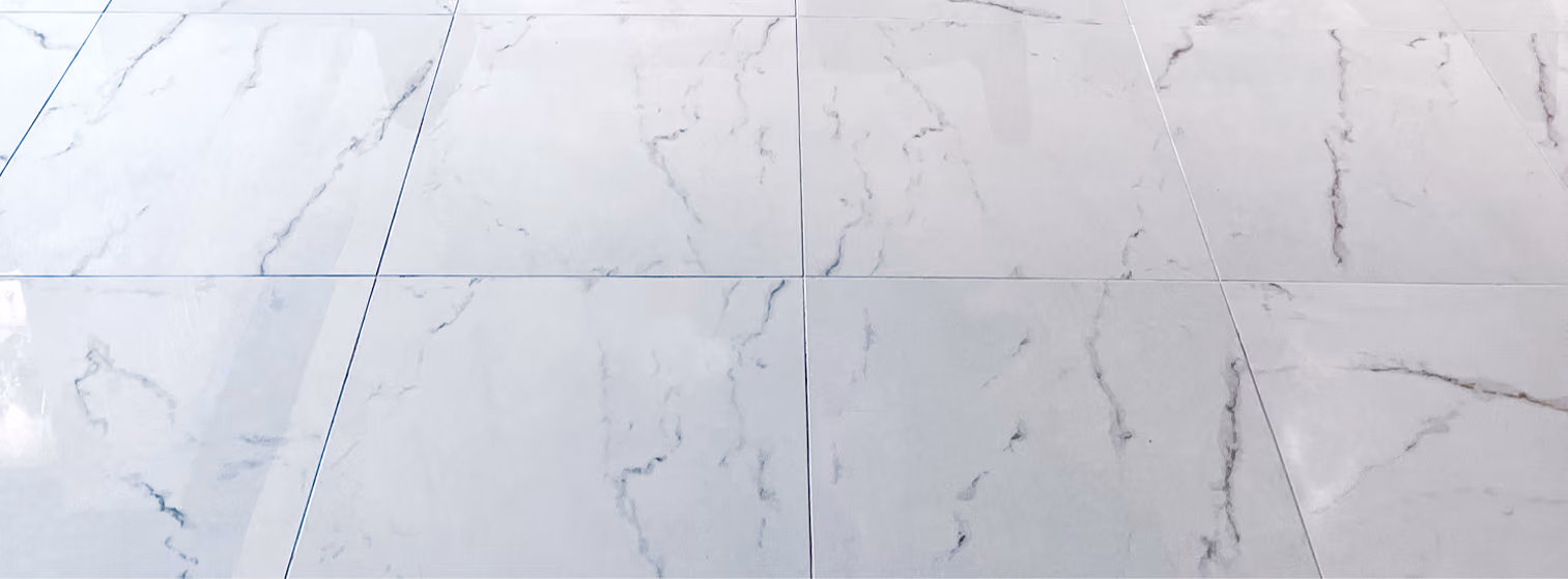 Close-up of white and gray marble-look tile flooring