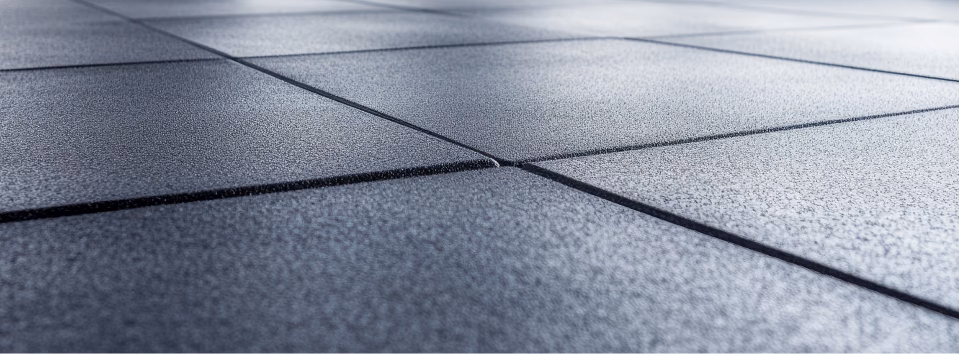 Close-up of gray large-format tile flooring installed on the diagonal