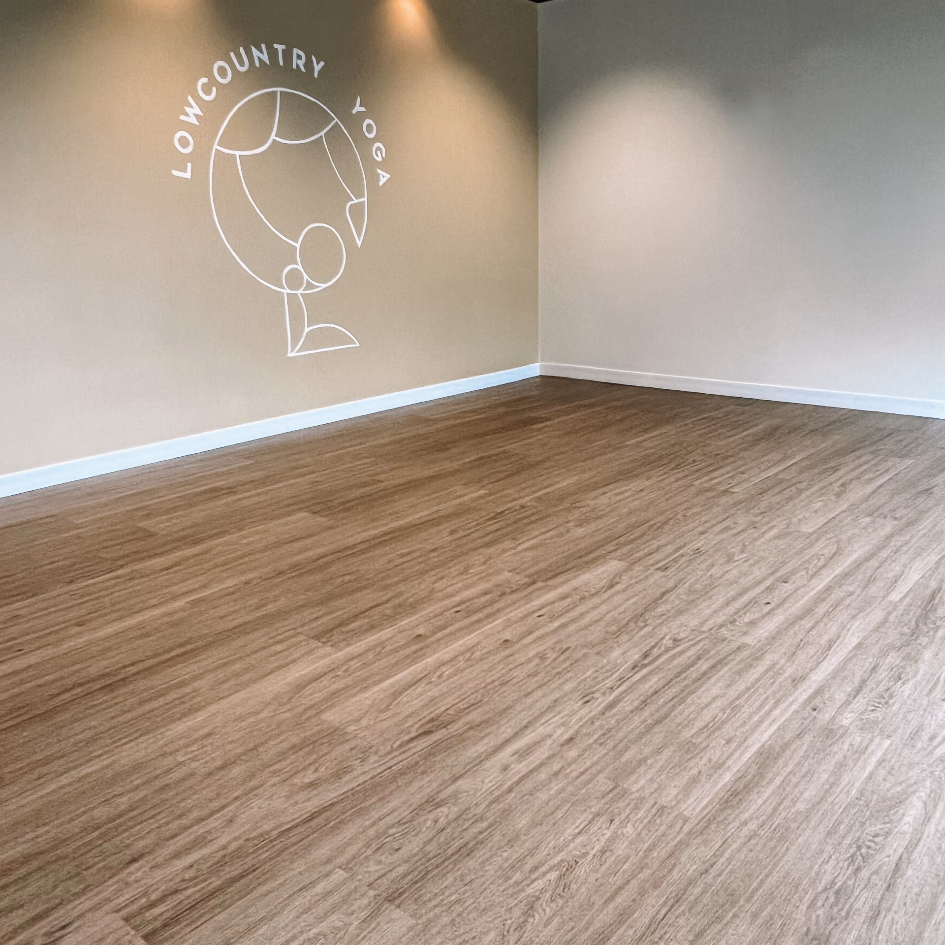 Empty commercial retail space with rich wood-look flooring
