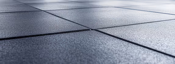 Close-up of light gray large-format tile flooring