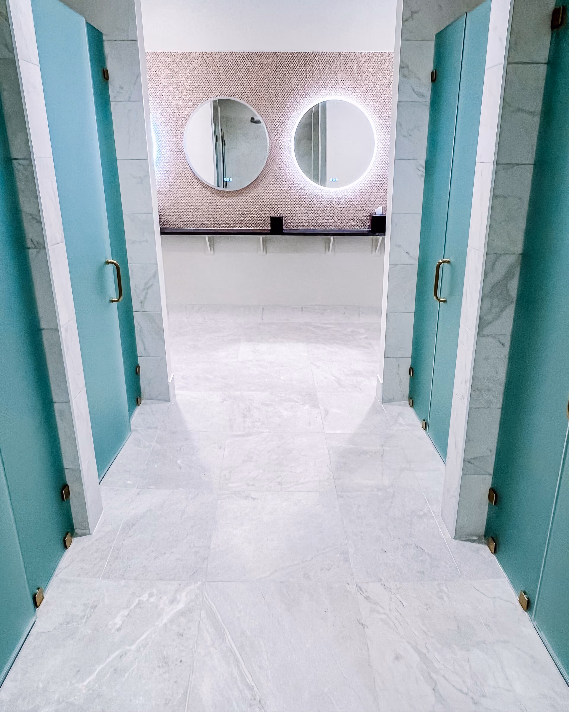 Commercial storefront entrance with teal walls and light tile flooring
