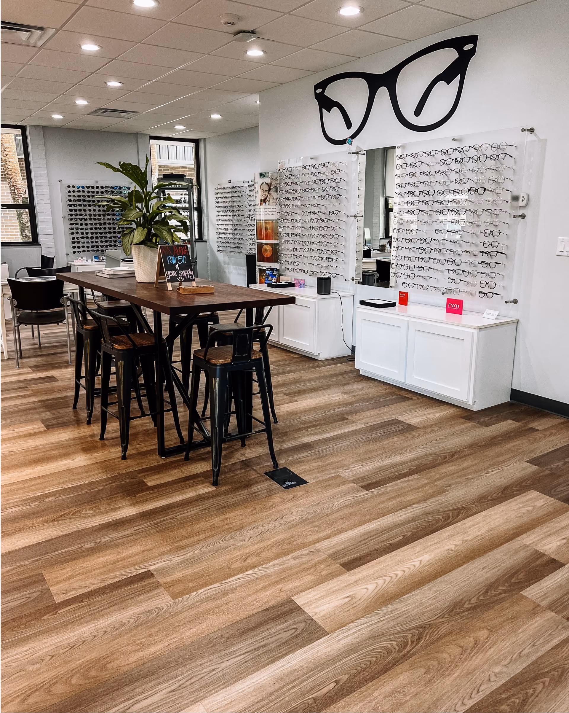 Commercial cafe seating area with pendant lighting and wood-look flooring