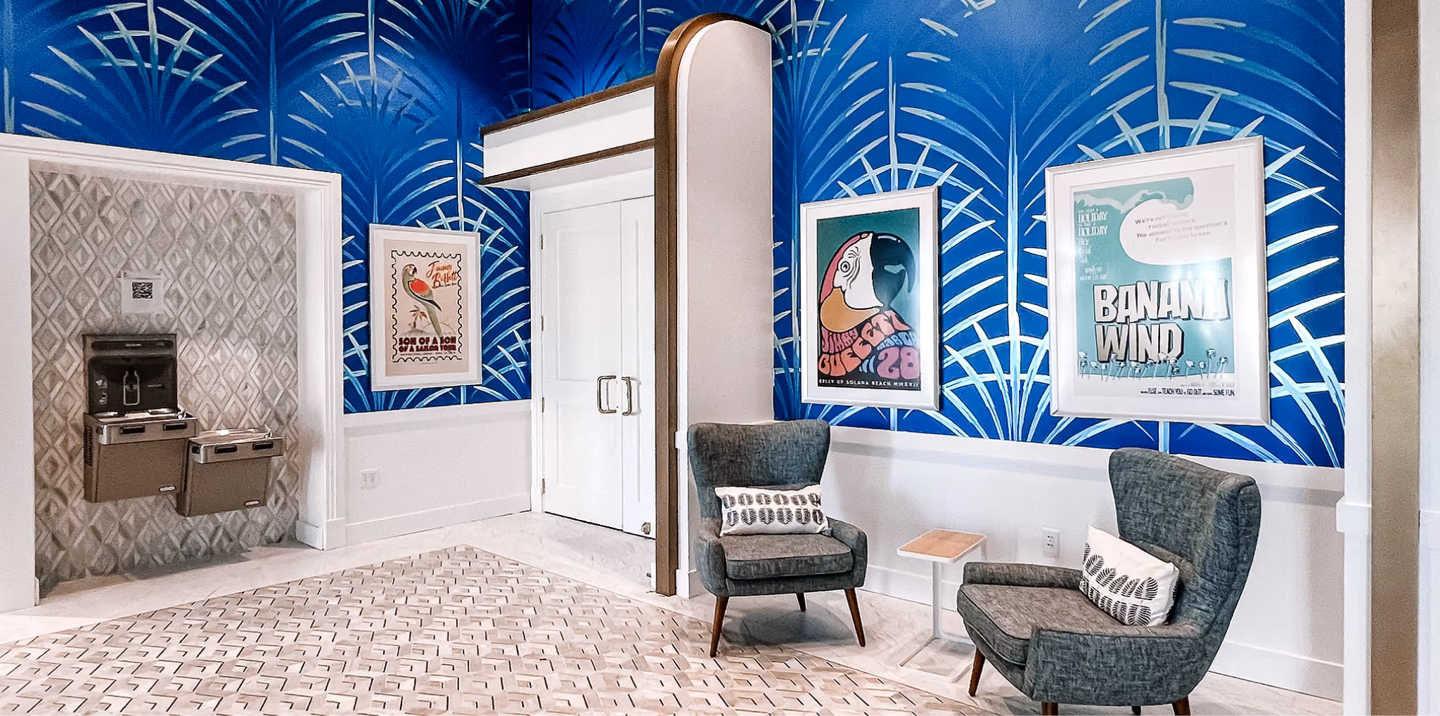 Senior living common area with a blue accent wall and light wood-look flooring