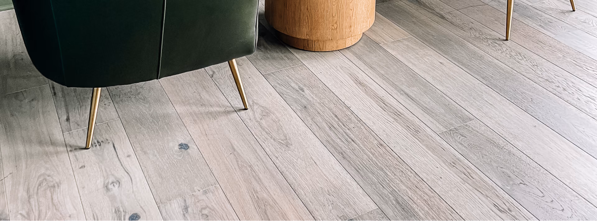 Close-up of light gray weathered wood-look plank flooring
