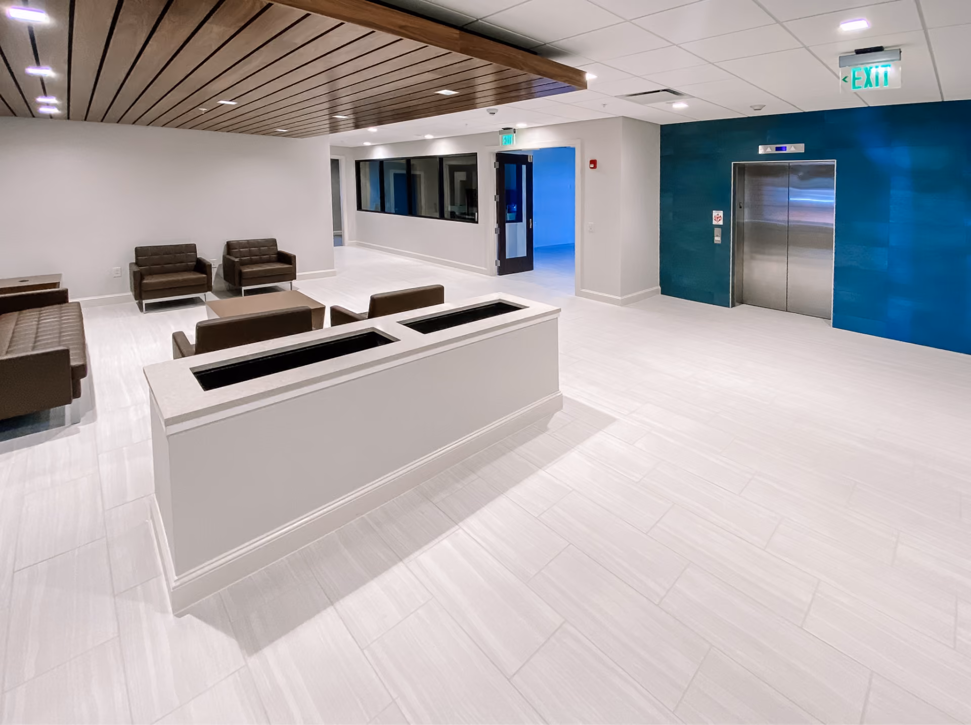 Bank lobby with a blue accent wall and dark tile flooring