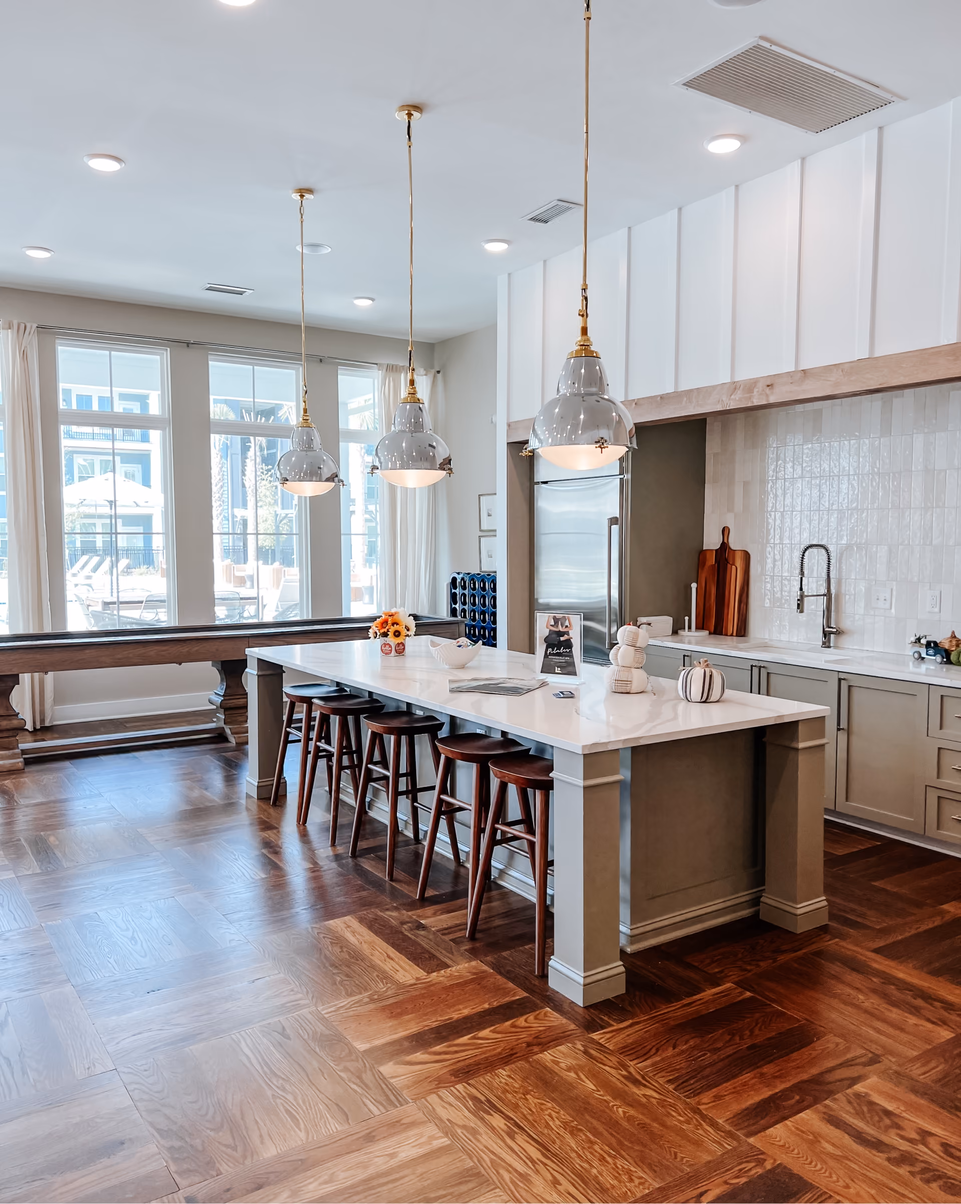 Hotel kitchenette with marble-look countertops and light wood-look flooring