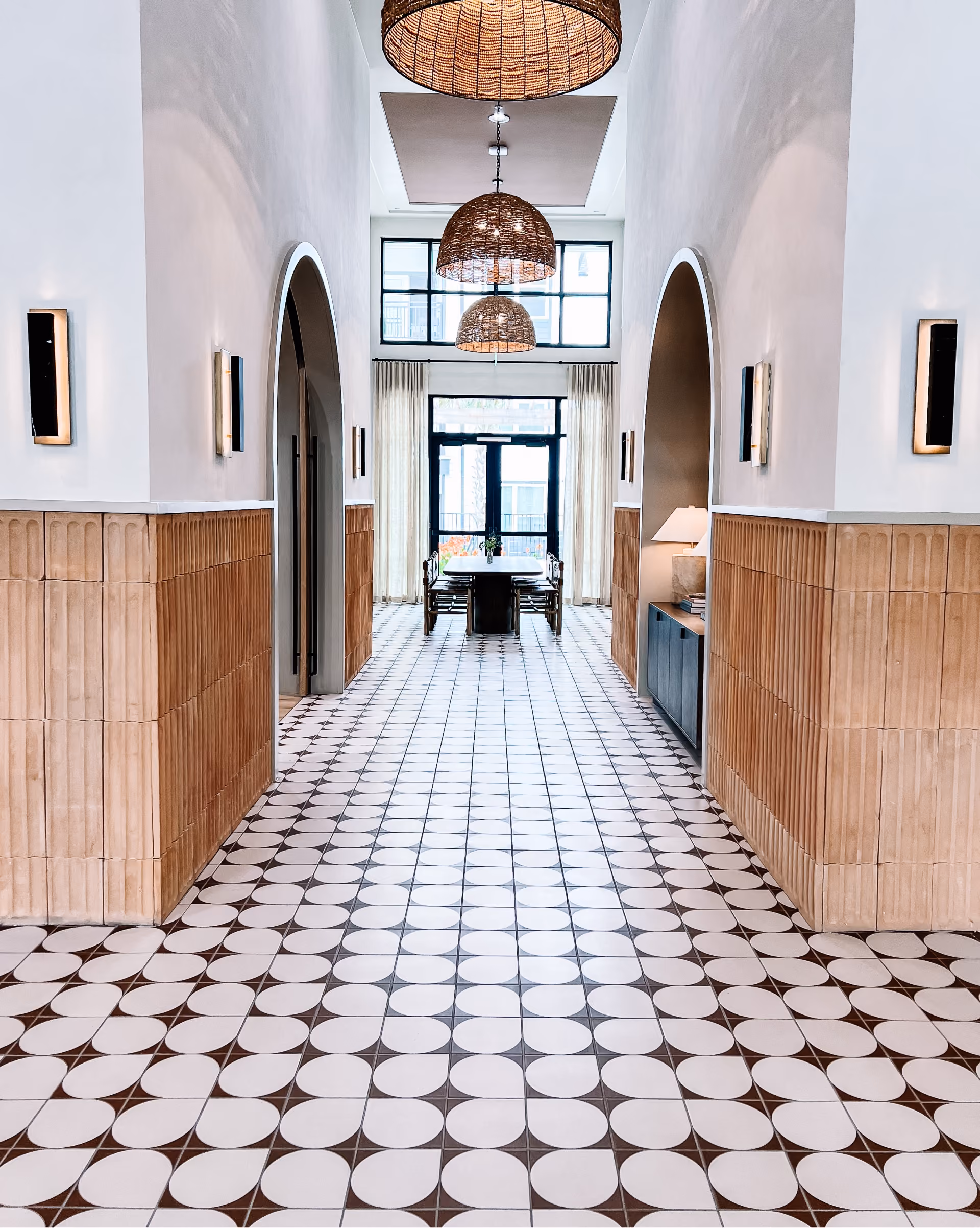 Hotel entryway with black and white patterned tile flooring