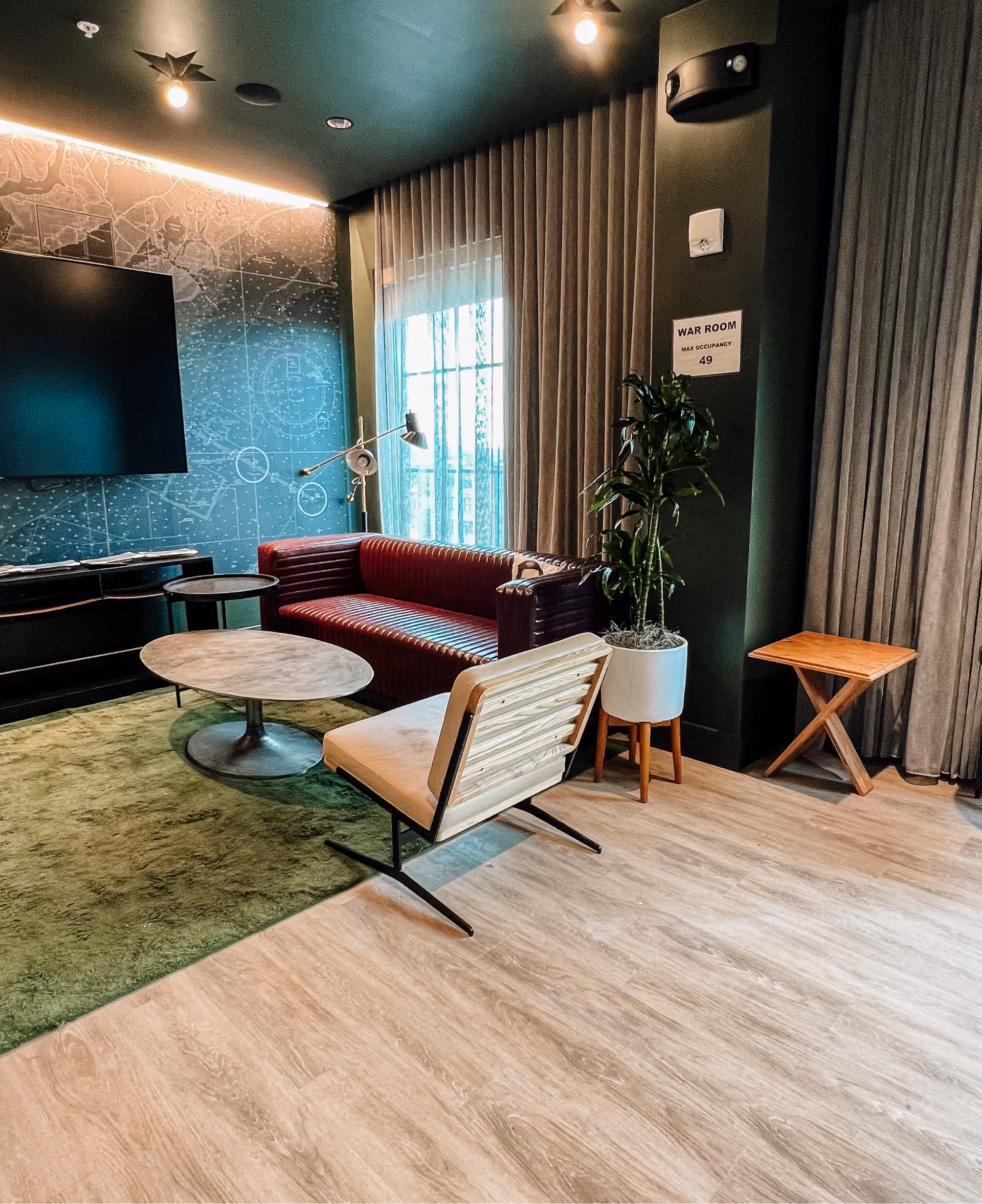Hotel lounge with teal sofas and patterned carpet flooring