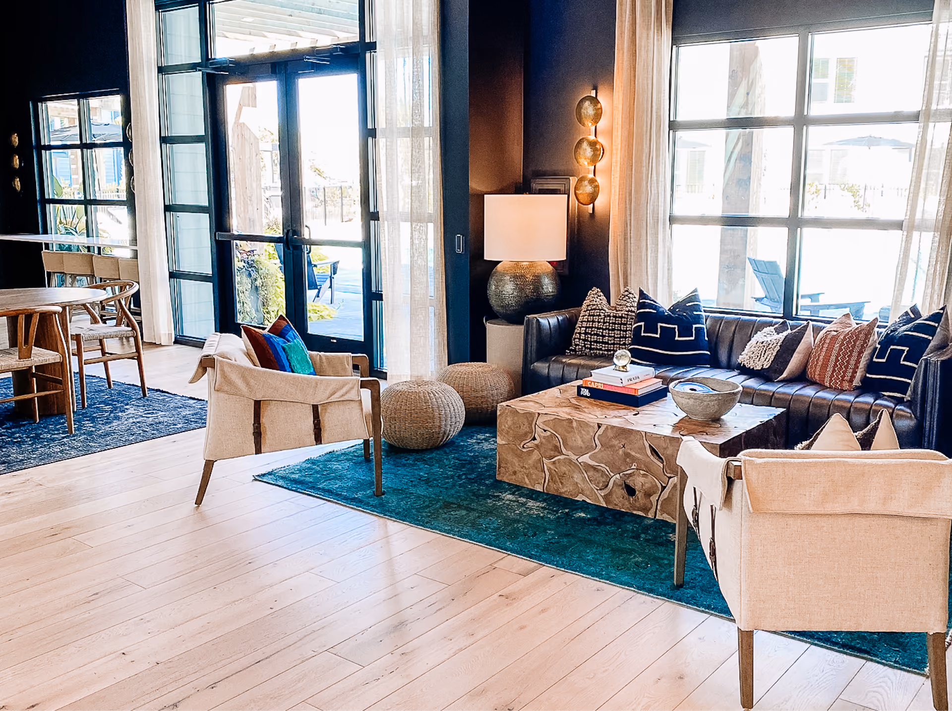Hotel lounge with blue armchairs and a patterned area rug