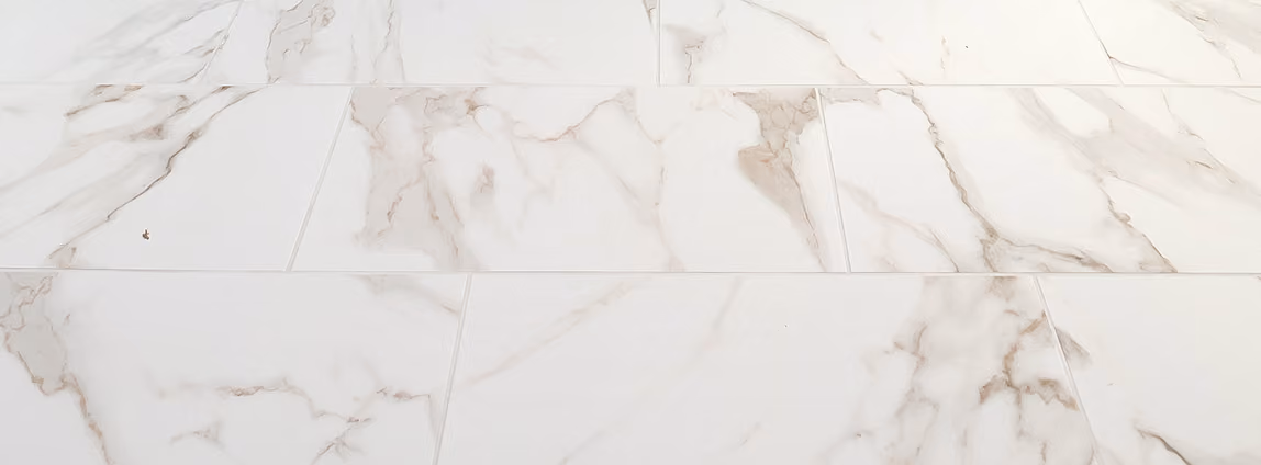 Close-up of white marble-look tile flooring